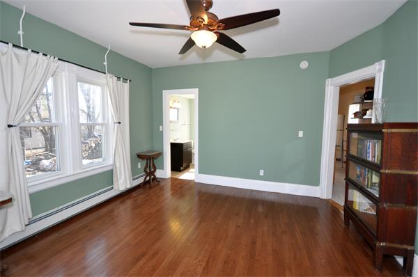 62 Central Street Framingham, MA 01701 - Photo 9 of 23 a view of an empty room with a window and wooden floor