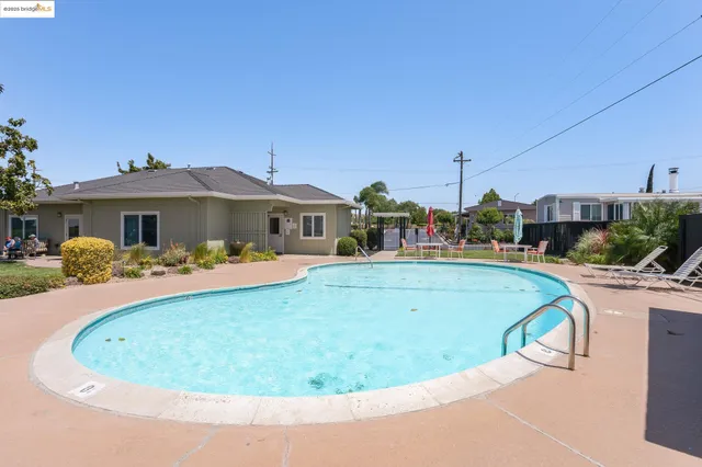 a front view of a house with a garden and yard