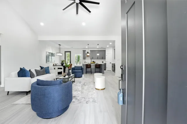 a living room with furniture and a chandelier