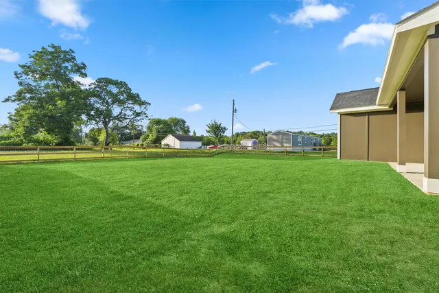a backyard of a house with lots of green space