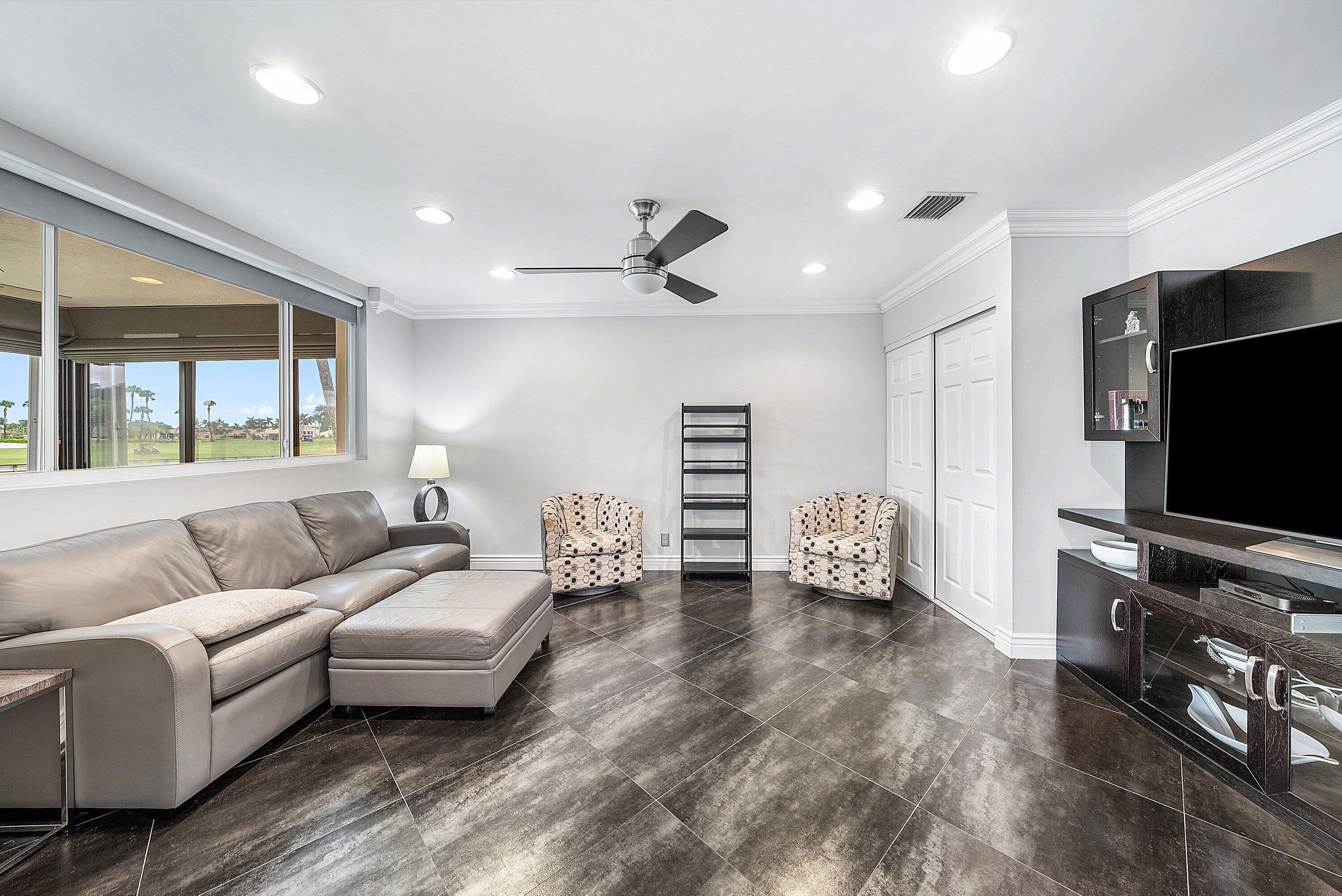 23 Eastgate Drive, Unit C Boynton Beach, FL 33436 - Photo 12 of 71 a living room with furniture and a flat screen tv