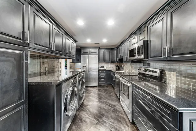 a view of a workspace with furniture and a bathroom