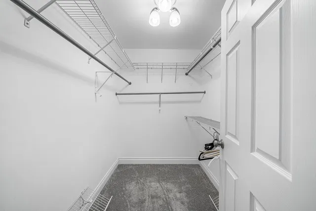 an aerial view of a house with a garden and lake view