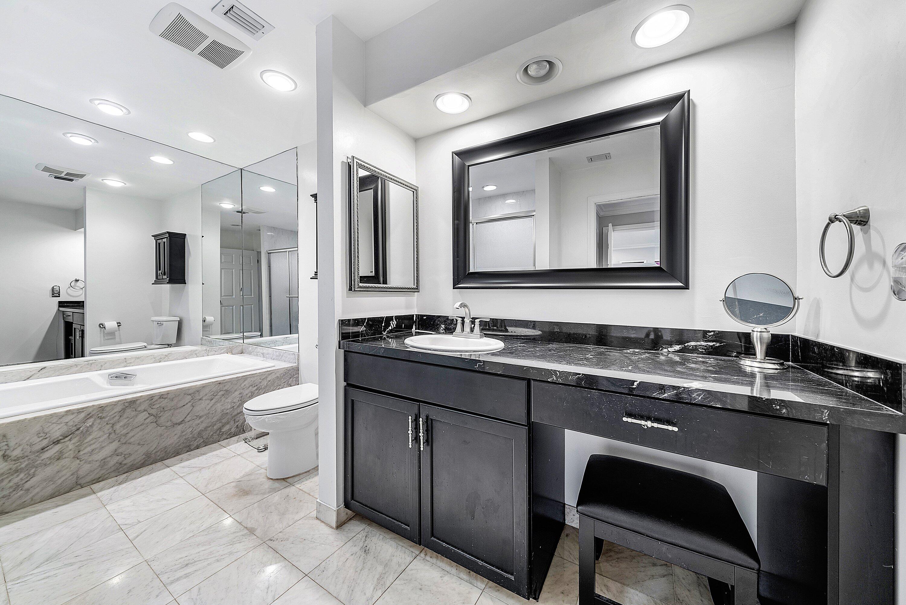 23 Eastgate Drive, Unit C Boynton Beach, FL 33436 - Photo 28 of 71 a bathroom with a granite countertop sink mirror and bathtub