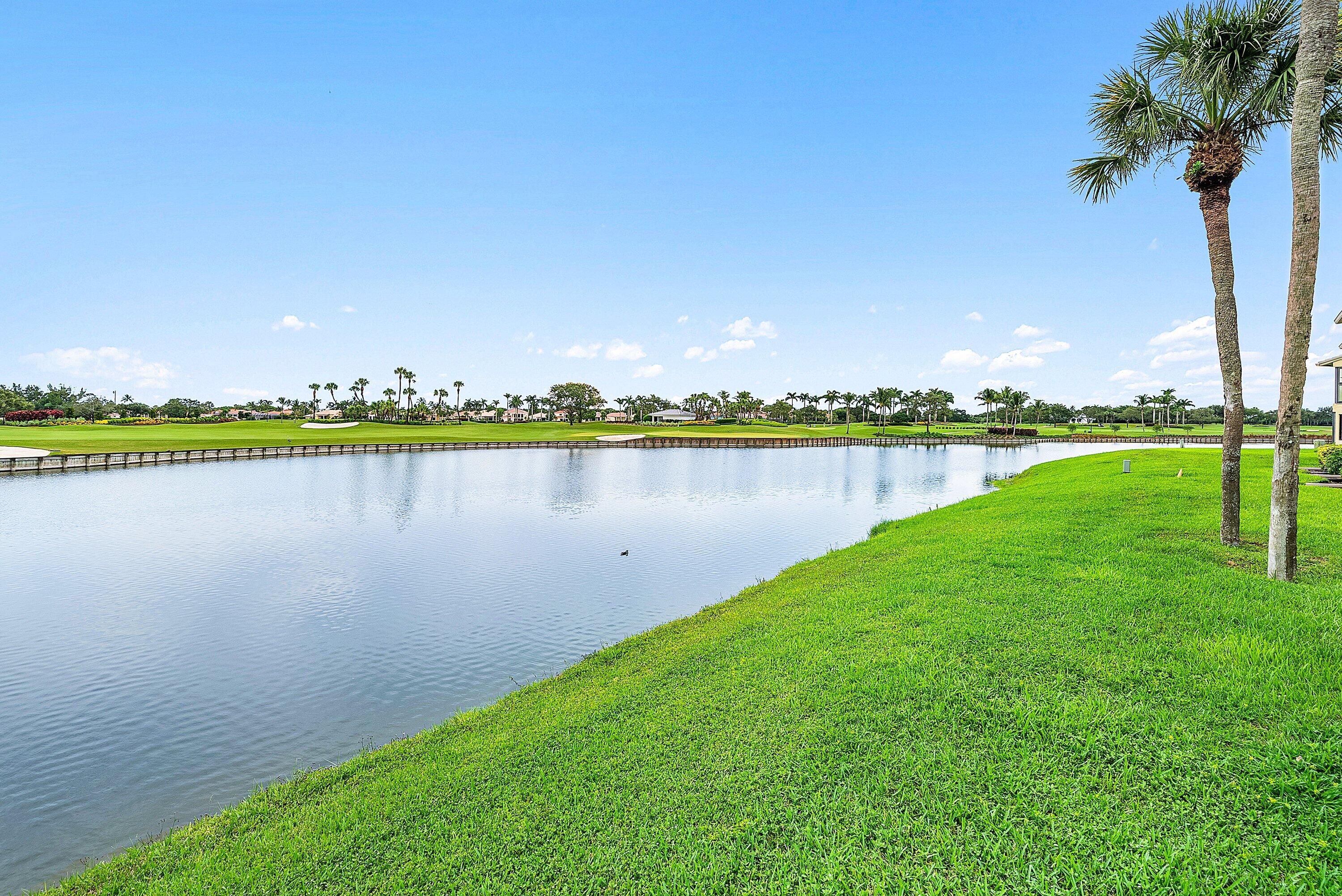 23 Eastgate Drive, Unit C Boynton Beach, FL 33436 - Photo 37 of 71 a view of a lake with houses in the back