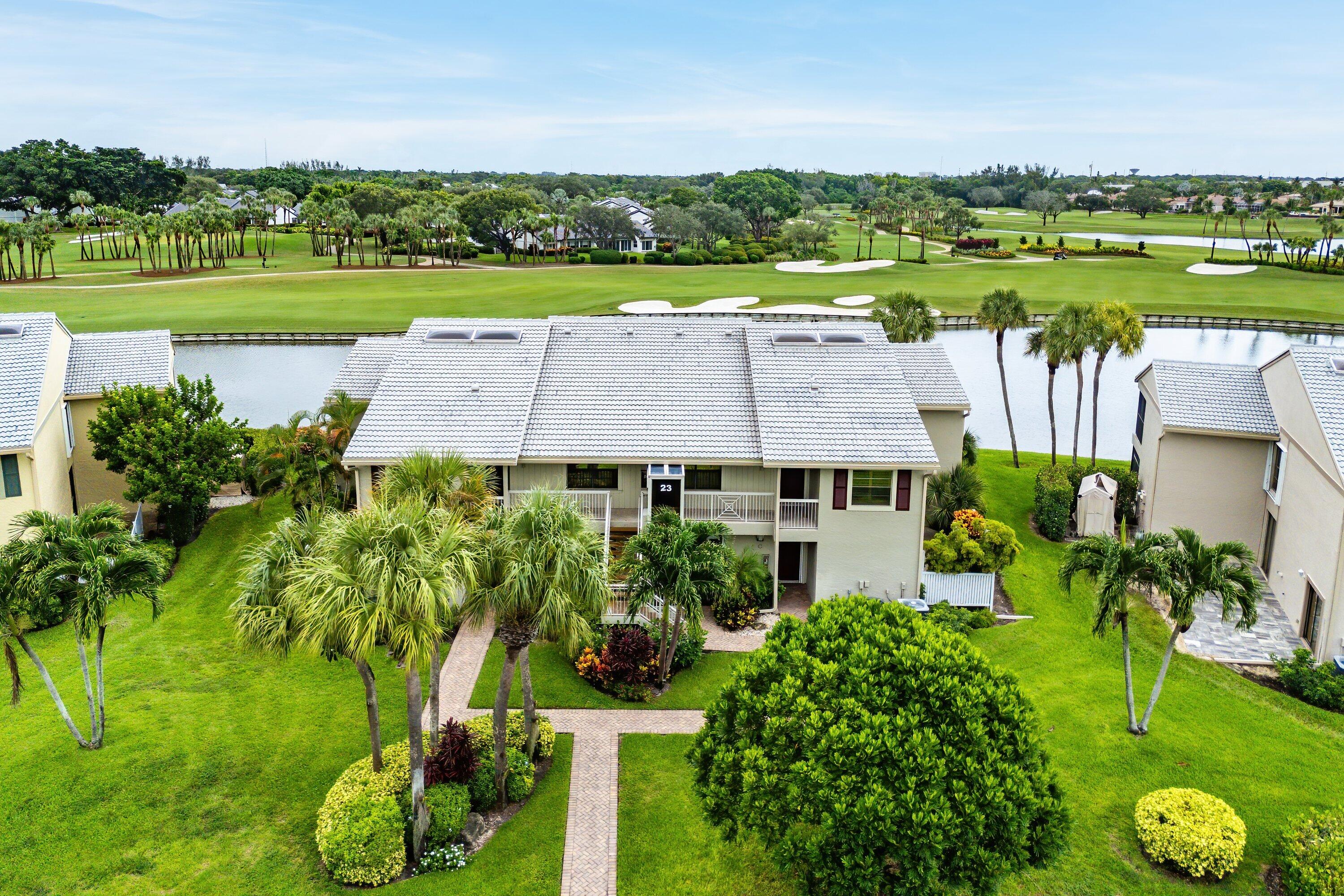 23 Eastgate Drive, Unit C Boynton Beach, FL 33436 - Photo 40 of 71 an aerial view of a house with a garden and lake view