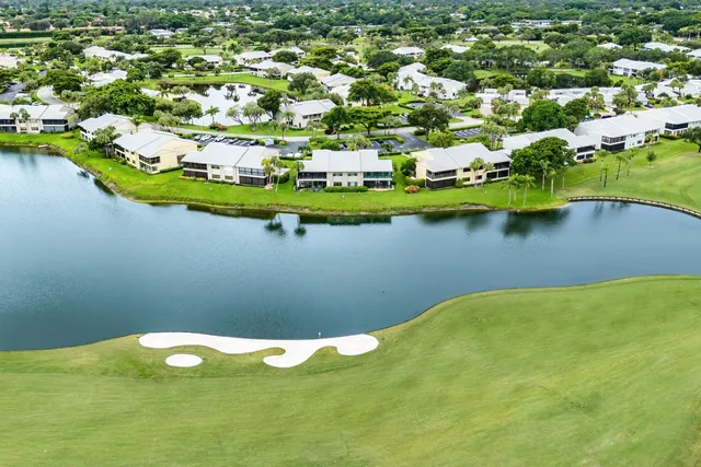 a view of a swimming pool with chairs in patio