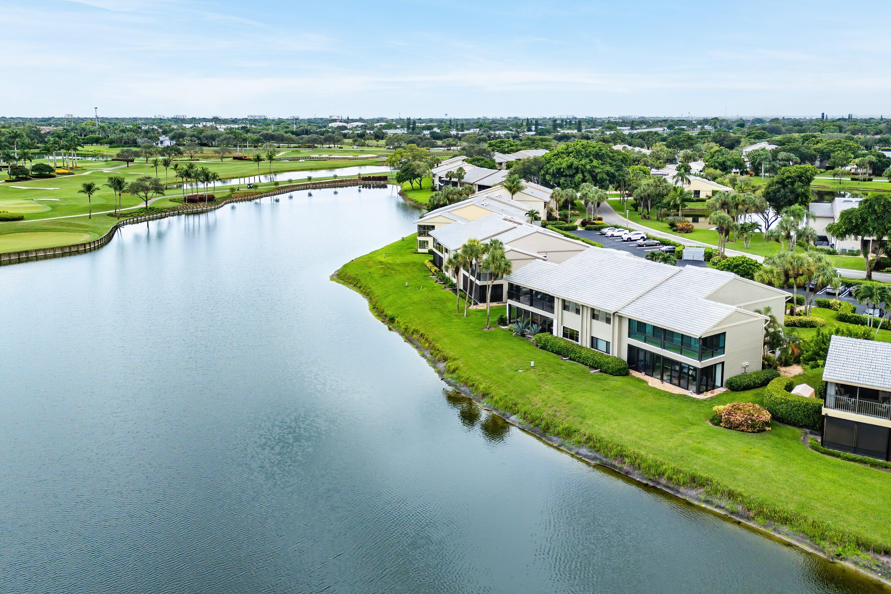 23 Eastgate Drive, Unit C Boynton Beach, FL 33436 - Photo 48 of 71 an aerial view of a house with a garden and lake view