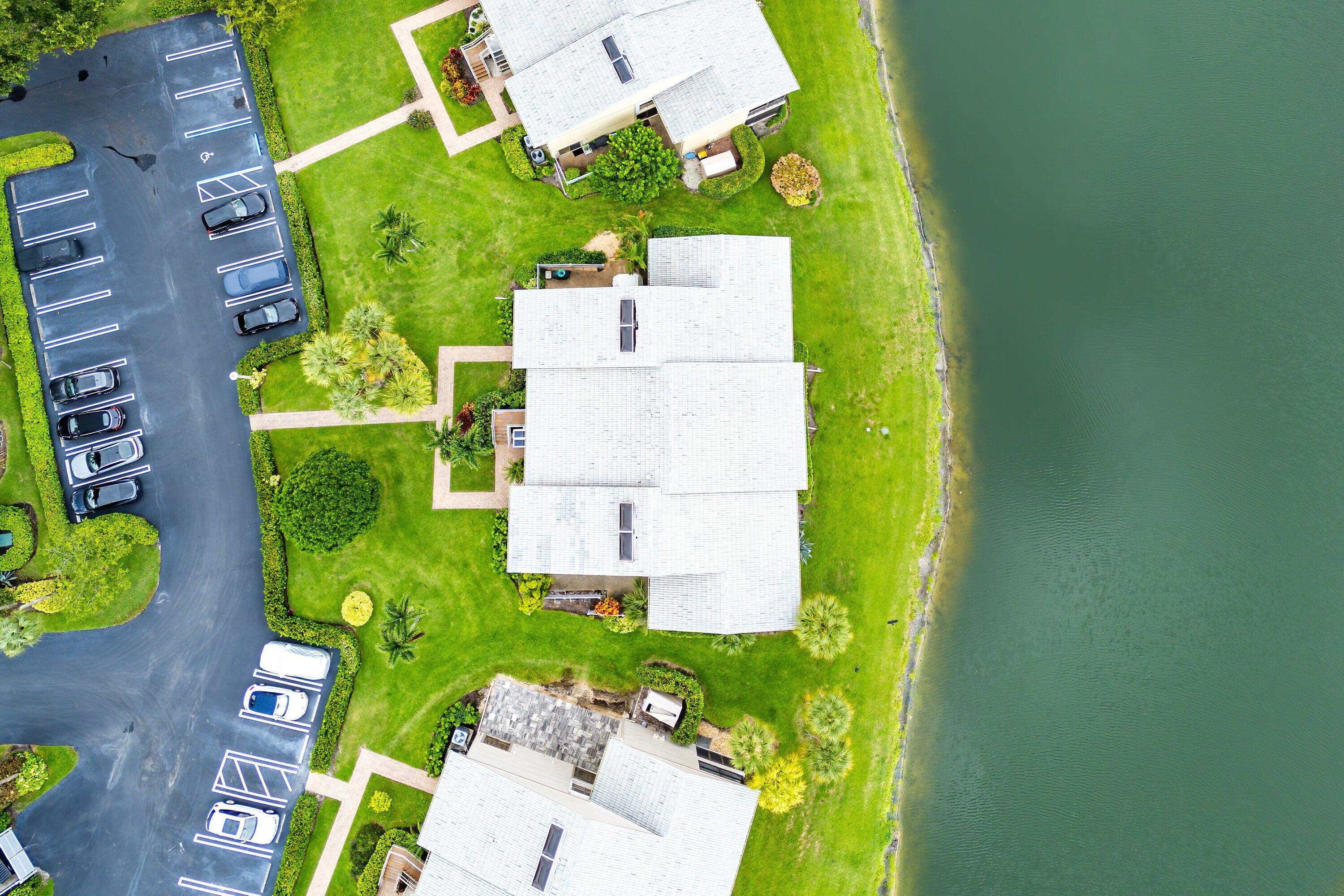 23 Eastgate Drive, Unit C Boynton Beach, FL 33436 - Photo 51 of 71 view of a swimming pool with a garden