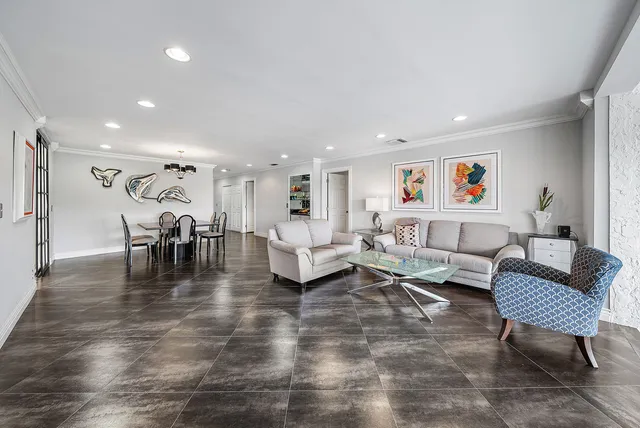 a living room filled with furniture and a large window