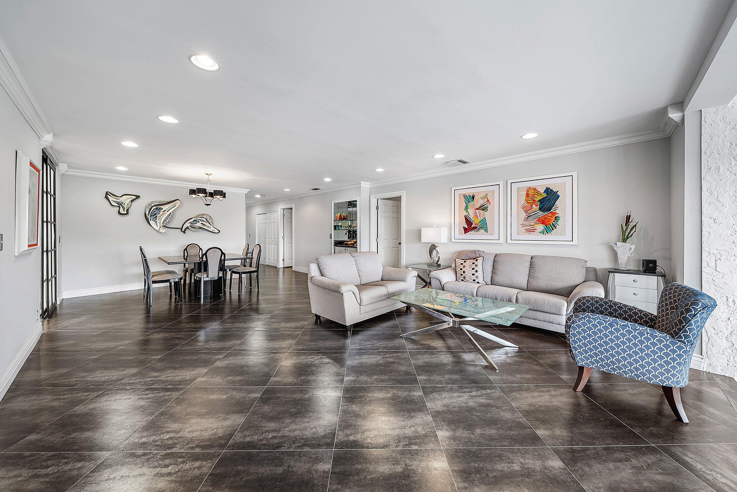 23 Eastgate Drive, Unit C Boynton Beach, FL 33436 - Photo 10 of 71 a living room with lots of furniture and a view of kitchen