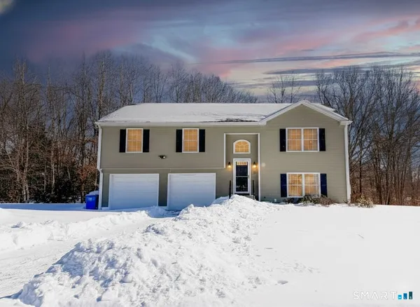a view of a house with a snow in the yard