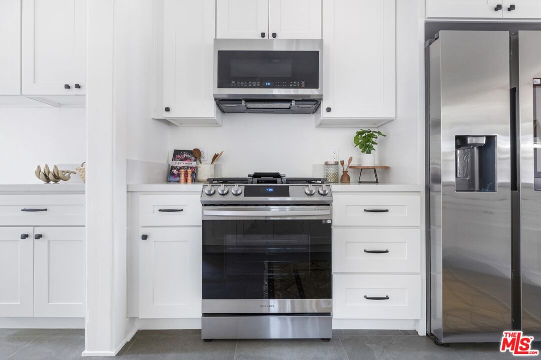 5228 Eagle Rock Boulevard Los Angeles, CA 90041 - Photo 20 of 51 a kitchen with stainless steel appliances a stove and a refrigerator