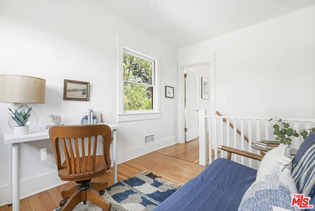 5228 Eagle Rock Boulevard Los Angeles, CA 90041 - Photo 28 of 51 a view of a workspace with furniture and a wooden floor