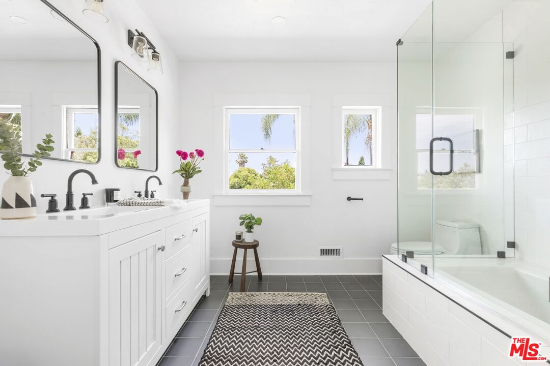 5228 Eagle Rock Boulevard Los Angeles, CA 90041 - Photo 33 of 51 a spacious bathroom with a double vanity sink a mirror a bathtub and next to a window