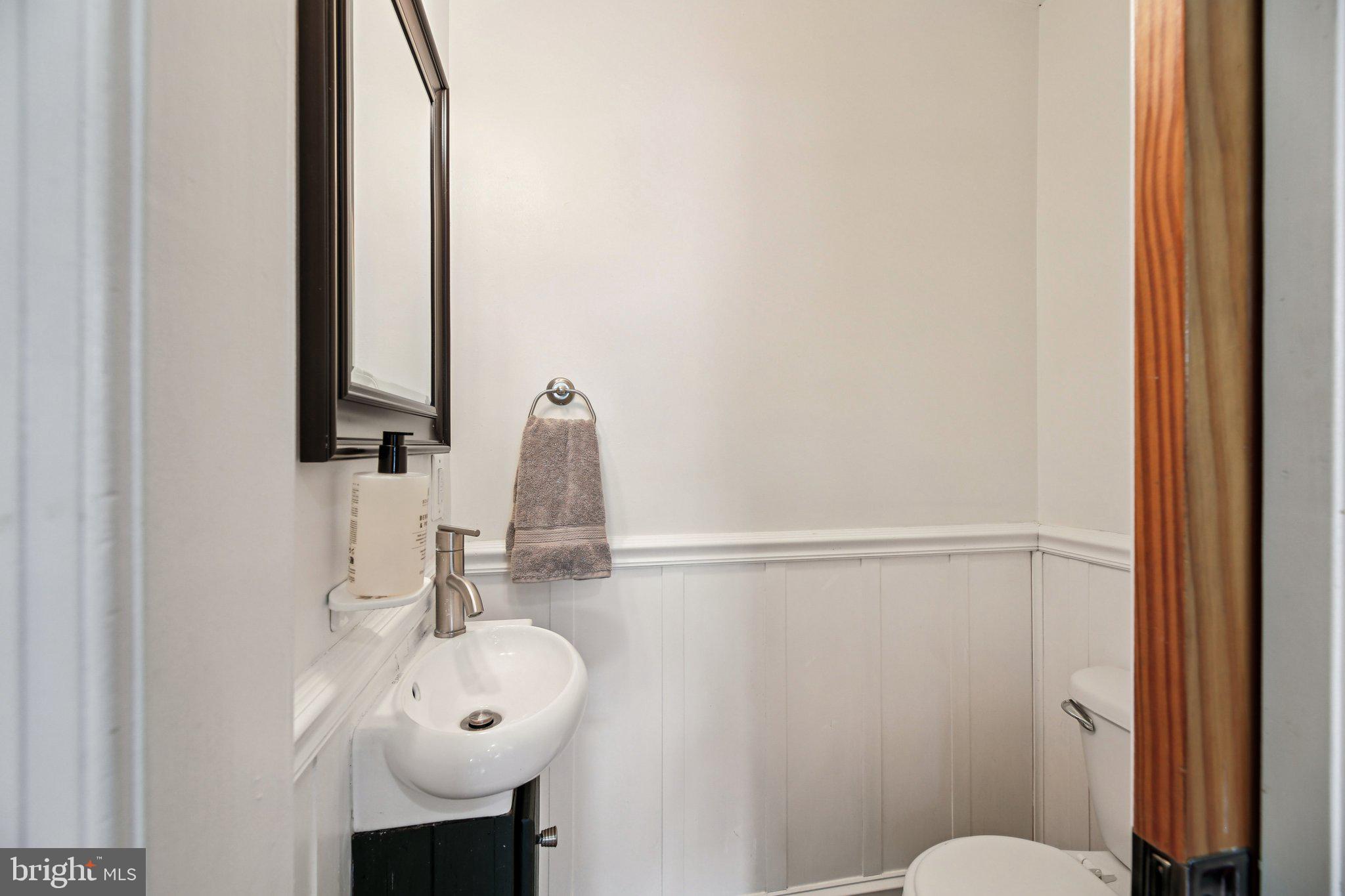 2341 Eastern Avenue Baltimore, MD 21224 - Photo 11 of 43 a bathroom with a sink a toilet and mirror