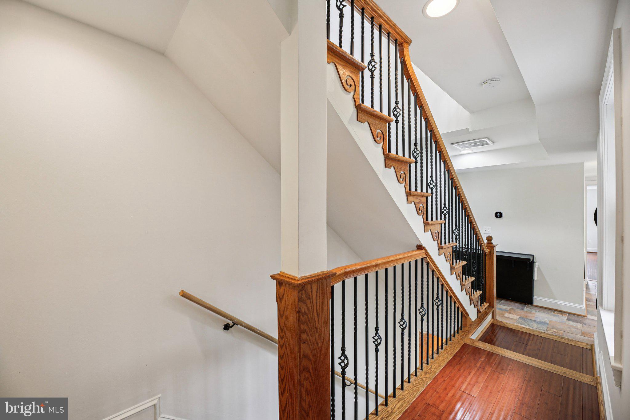 2341 Eastern Avenue Baltimore, MD 21224 - Photo 14 of 43 a view of staircase with wooden floor and white walls