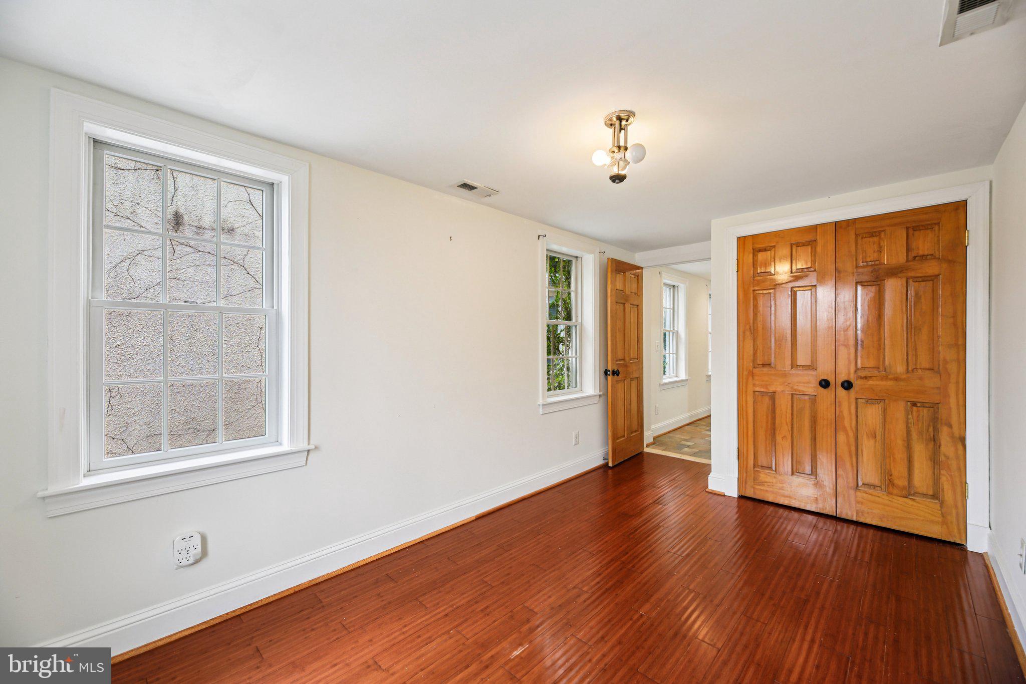 2341 Eastern Avenue Baltimore, MD 21224 - Photo 18 of 43 a view of an empty room with wooden floor and a window
