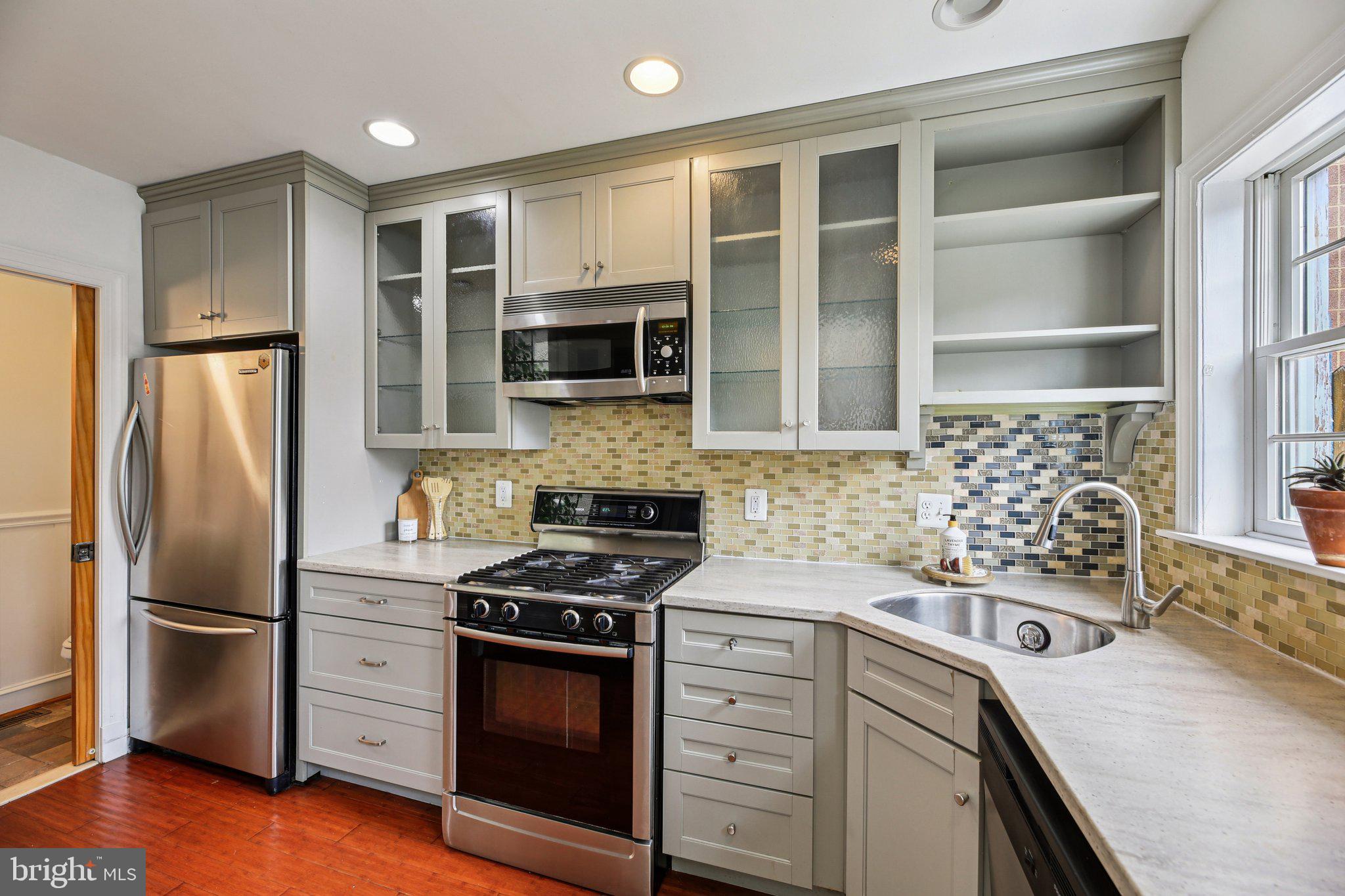 2341 Eastern Avenue Baltimore, MD 21224 - Photo 2 of 43 a kitchen with stainless steel appliances a stove a sink and a refrigerator