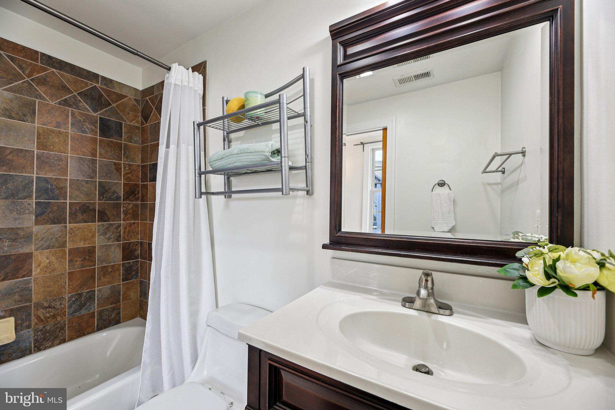 2341 Eastern Avenue Baltimore, MD 21224 - Photo 22 of 43 a bathroom with a sink and a mirror