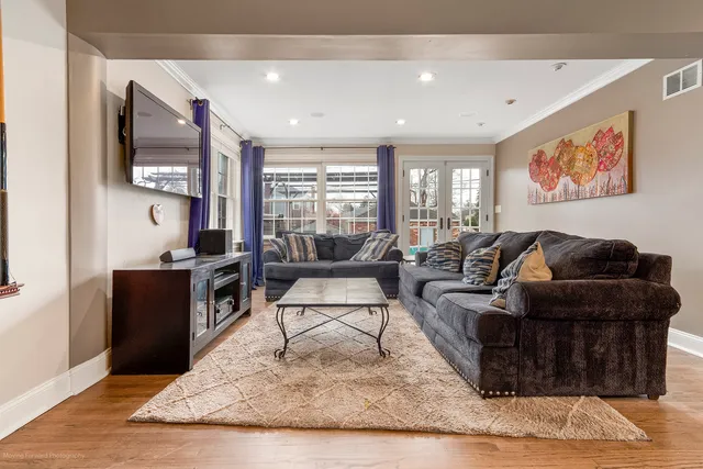 a living room with furniture large window and flat screen tv
