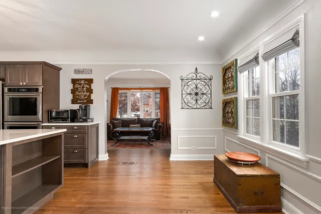 a kitchen with granite countertop stainless steel appliances and wooden floor