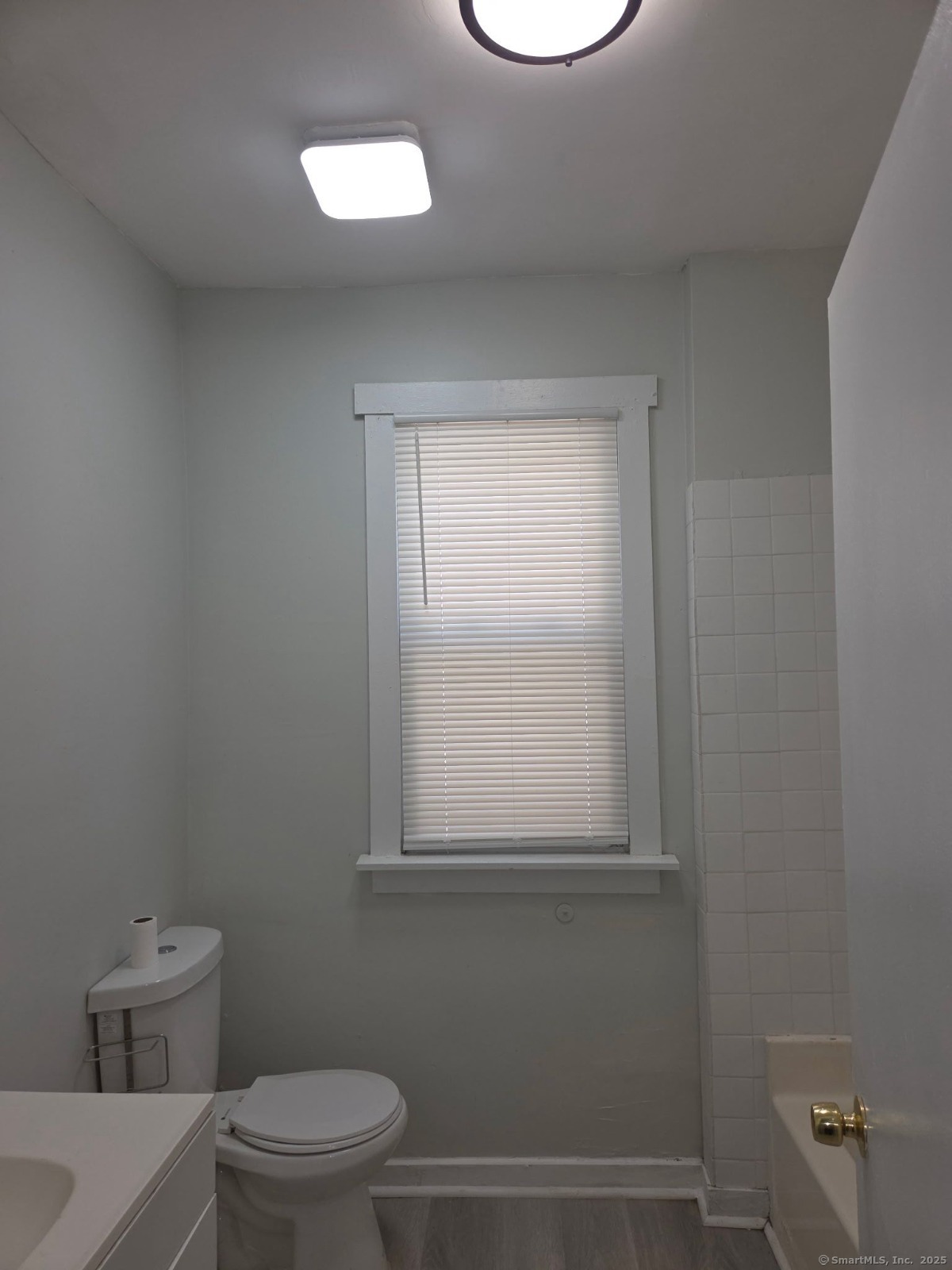 43 Gilbert Avenue New Haven, CT 06511 - Photo 13 of 14 a bathroom with a toilet a sink and a window