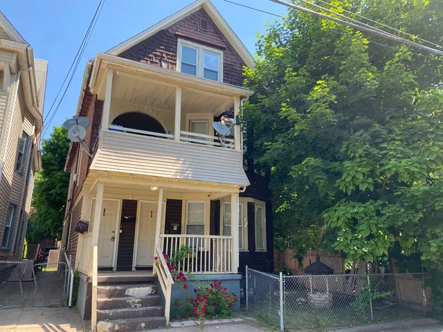 a front view of a house with a porch