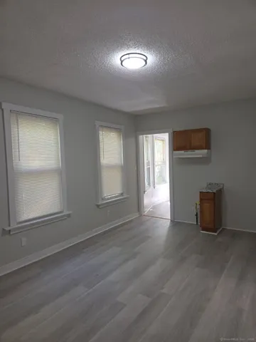 a view of a room with wooden floor