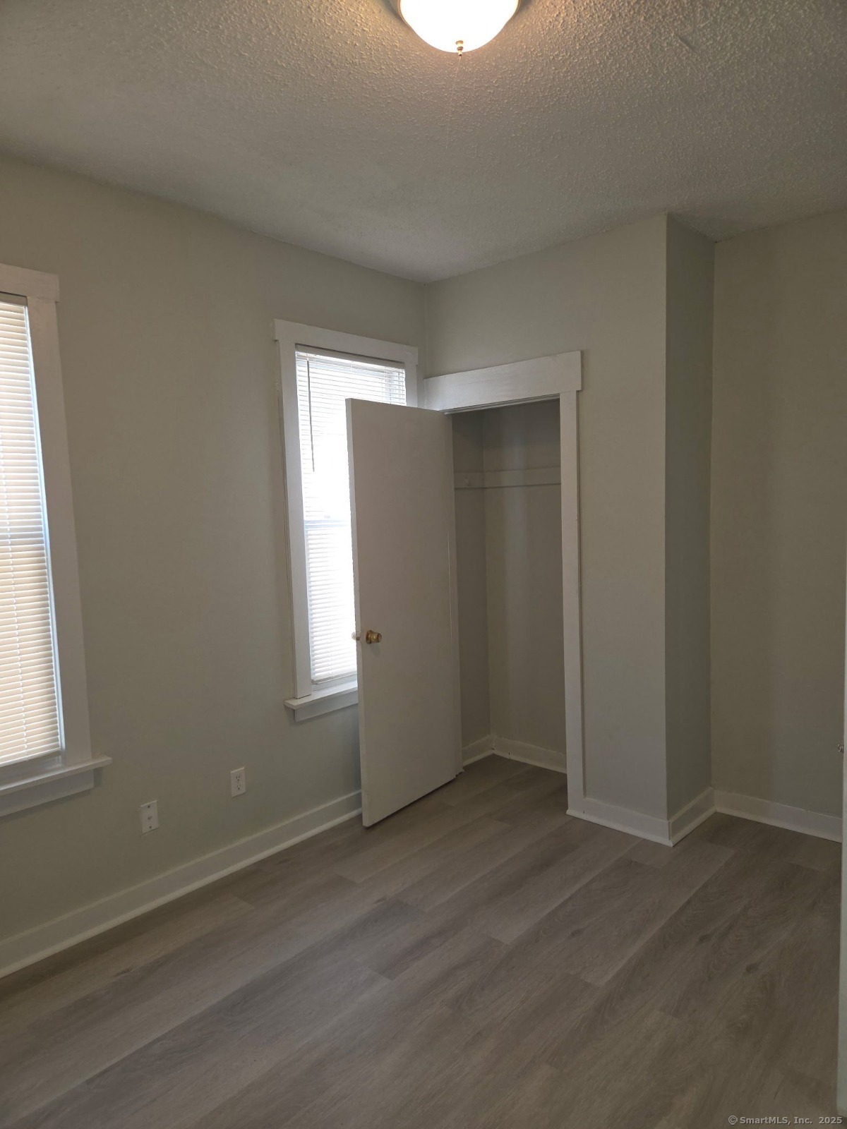 43 Gilbert Avenue New Haven, CT 06511 - Photo 8 of 14 an empty room with wooden floor and windows