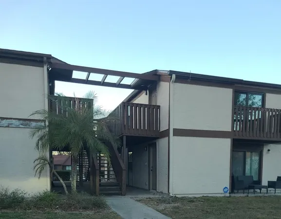 a view of a house with backyard and deck