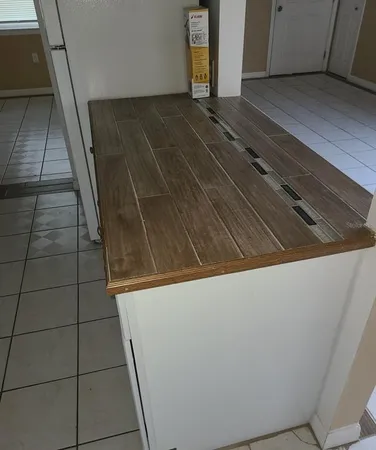a kitchen with granite countertop white cabinets and black appliances