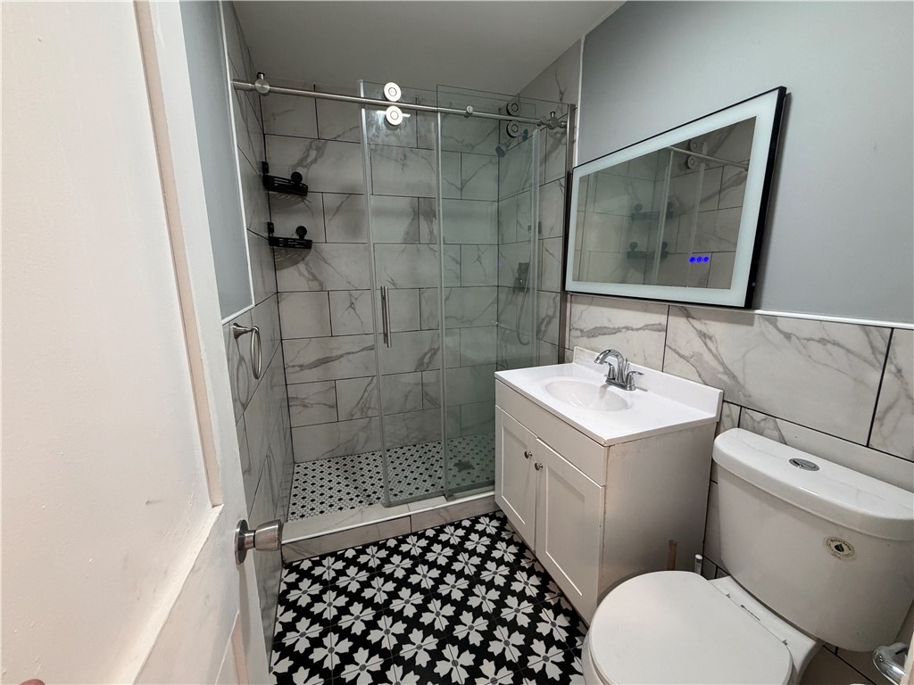 302 Sirrine Street Honea Path, SC 29654 - Photo 14 of 24 Elegant shower and vanity, designed with contemporary finishes and stylish fixtures.