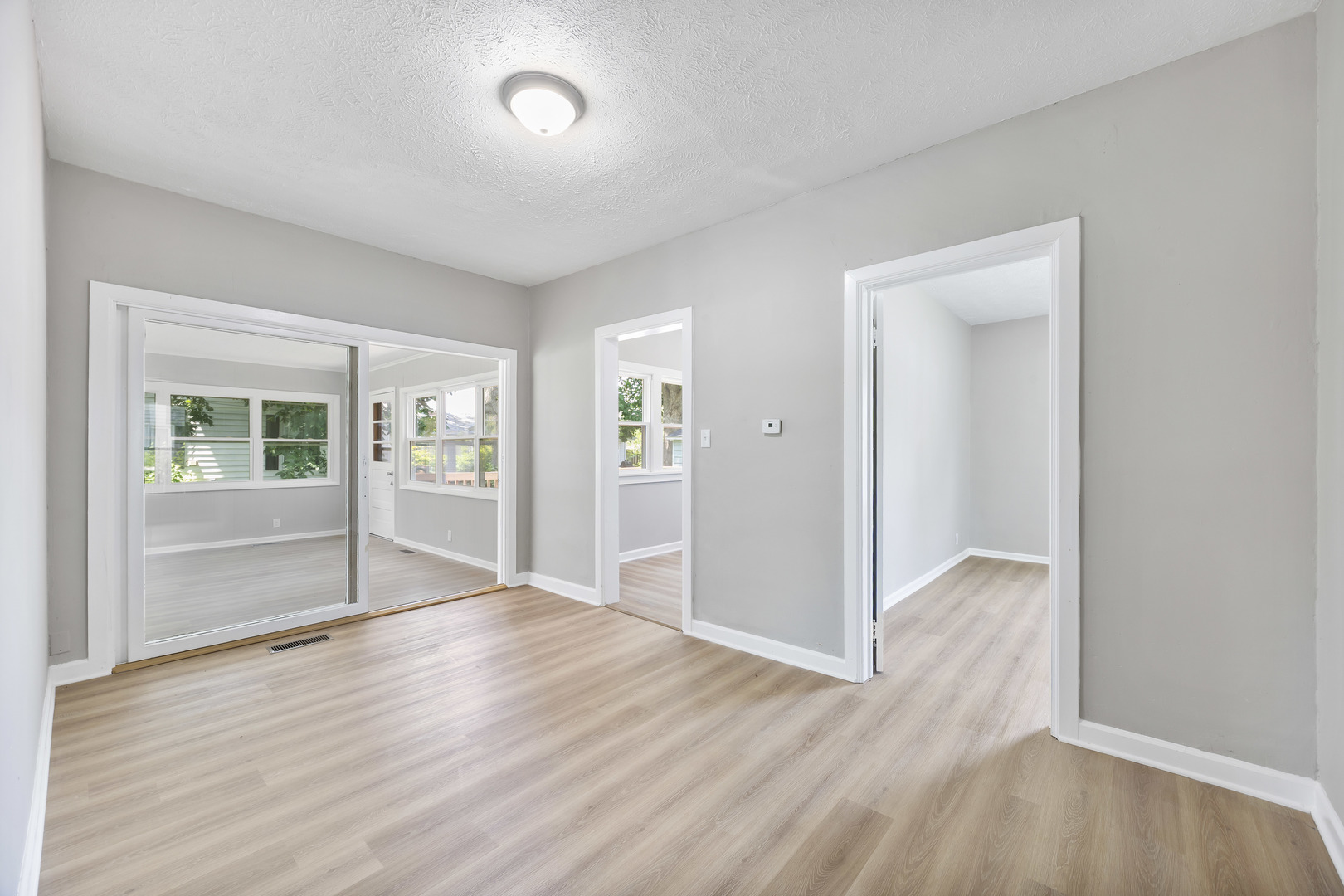 722 East Madison Avenue Chrisman, IL 61924 - Photo 11 of 23 an empty room with wooden floor and windows