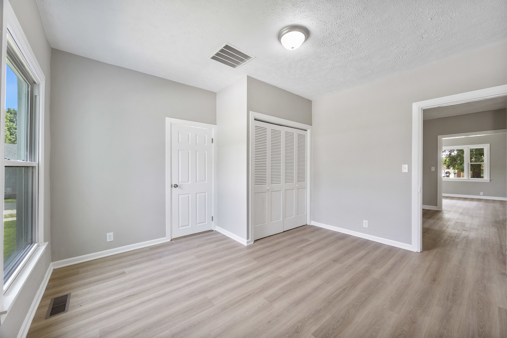 722 East Madison Avenue Chrisman, IL 61924 - Photo 15 of 23 an empty room with wooden floor and windows