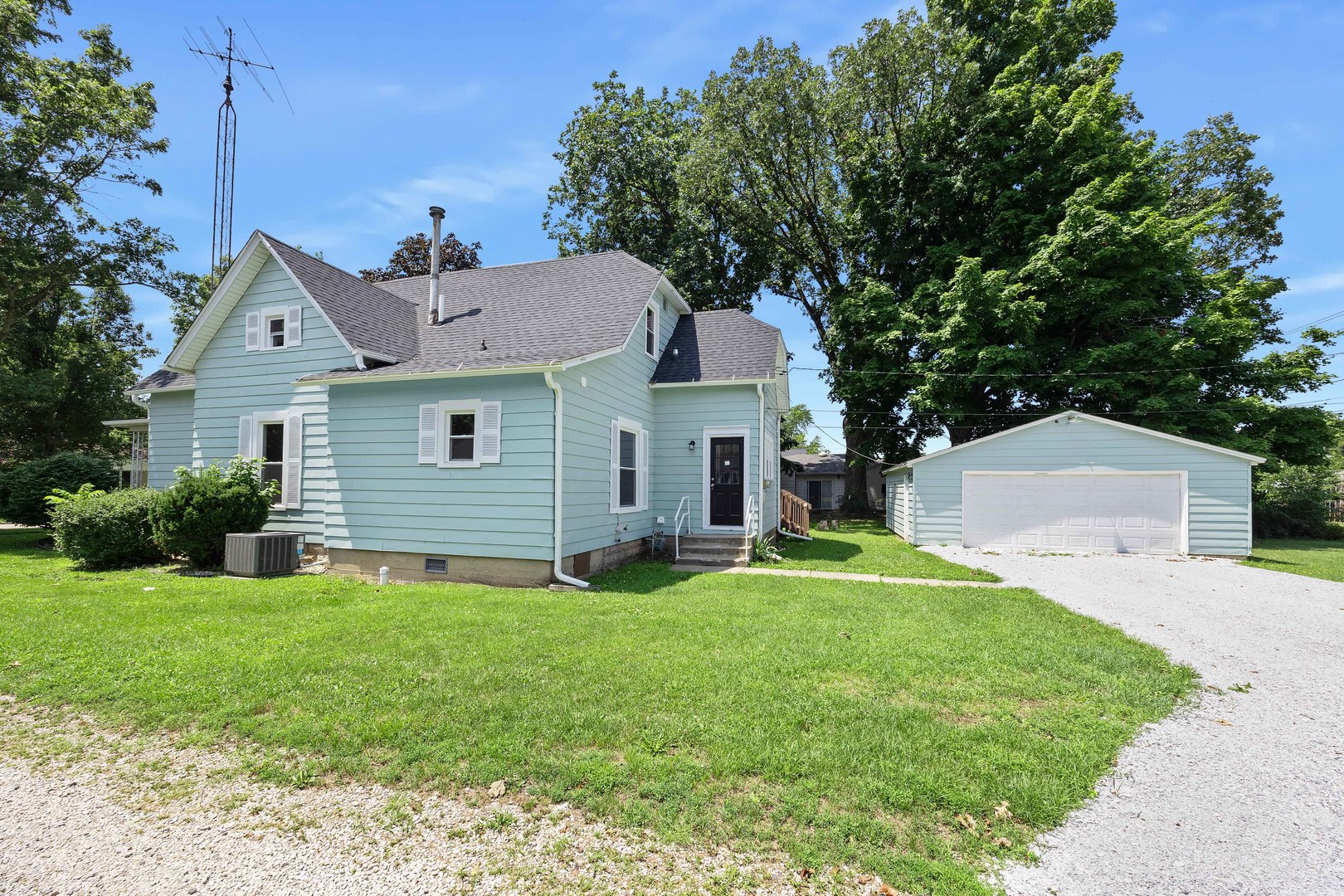 722 East Madison Avenue Chrisman, IL 61924 - Photo 2 of 23 a front view of a house with a yard and garage