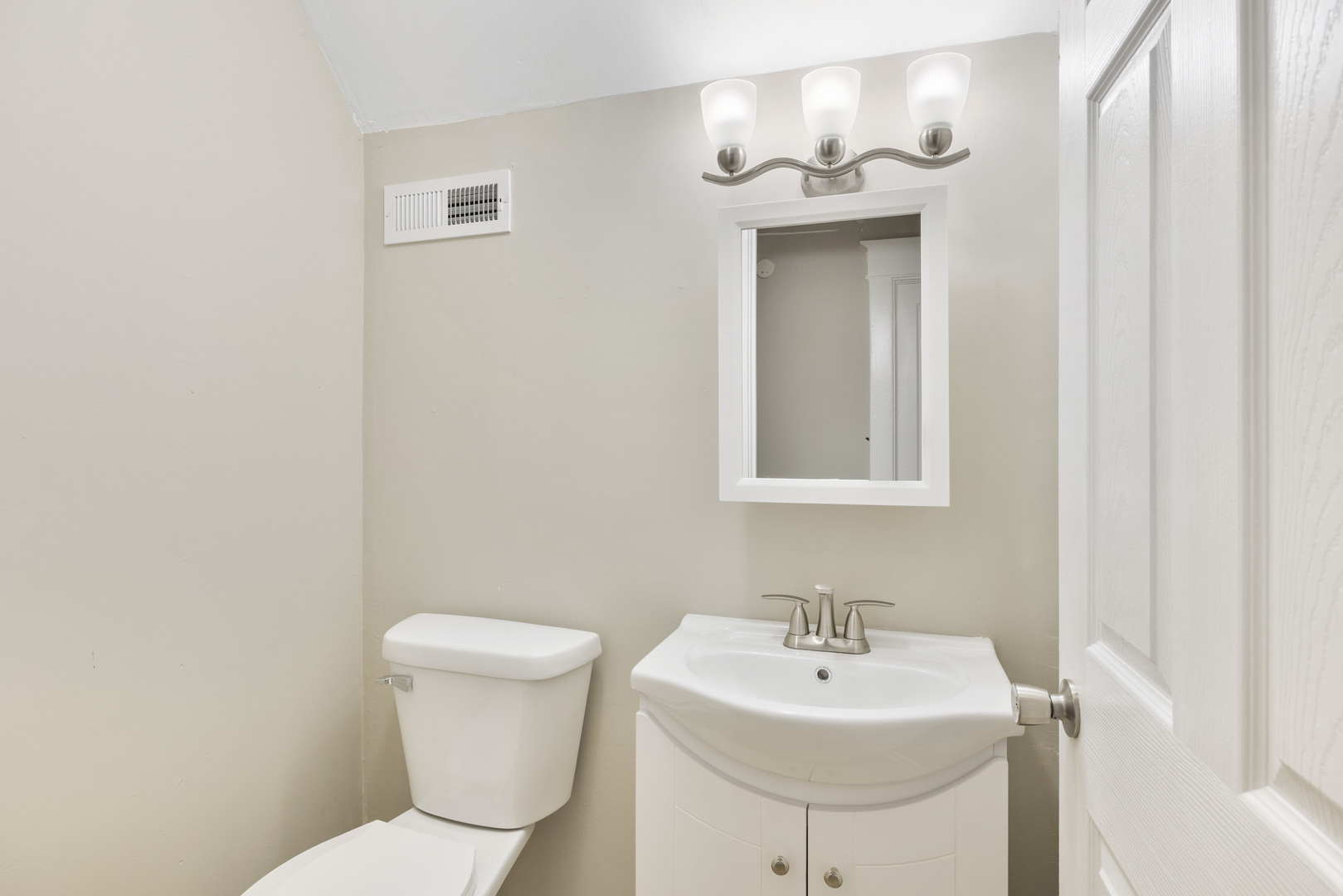 722 East Madison Avenue Chrisman, IL 61924 - Photo 22 of 23 a bathroom with a toilet sink and mirror