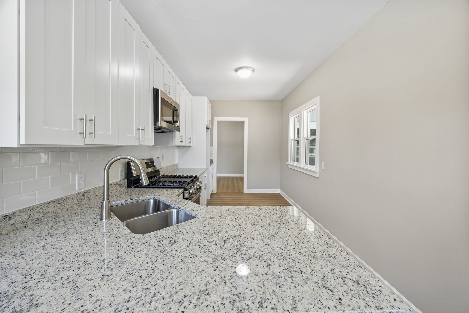 722 East Madison Avenue Chrisman, IL 61924 - Photo 7 of 23 a kitchen with stainless steel appliances granite countertop a sink stove and refrigerator