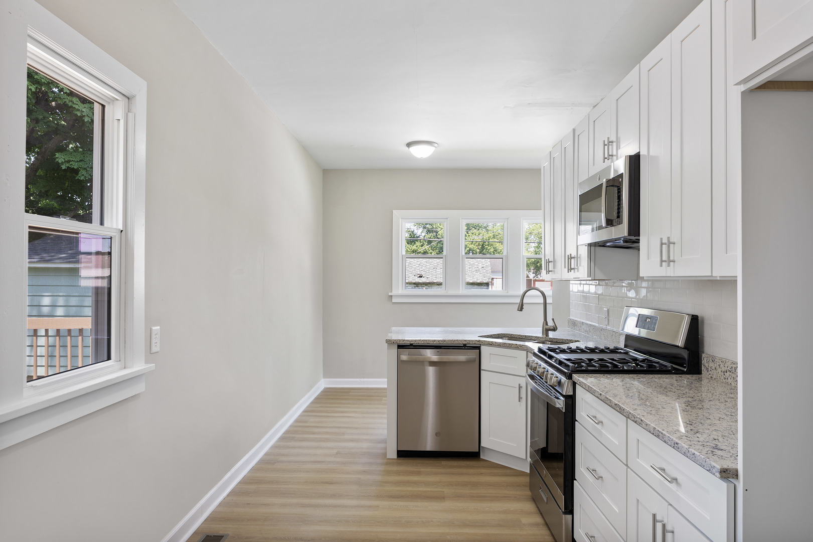 722 East Madison Avenue Chrisman, IL 61924 - Photo 9 of 23 a kitchen with stainless steel appliances a sink cabinets and a window