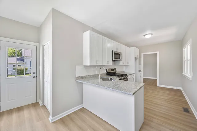 a kitchen with a stove a sink and a refrigerator