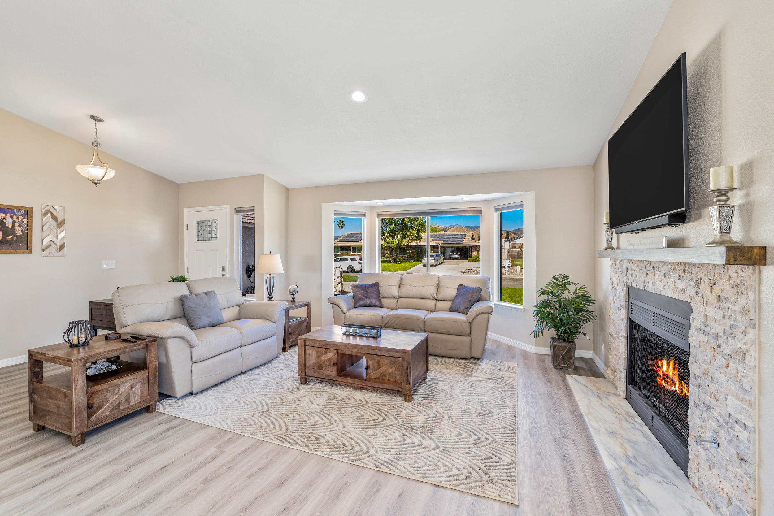 33727 Liberty Road Yucaipa, CA 92399 - Photo 4 of 39 a living room with furniture a flat screen tv and a fireplace