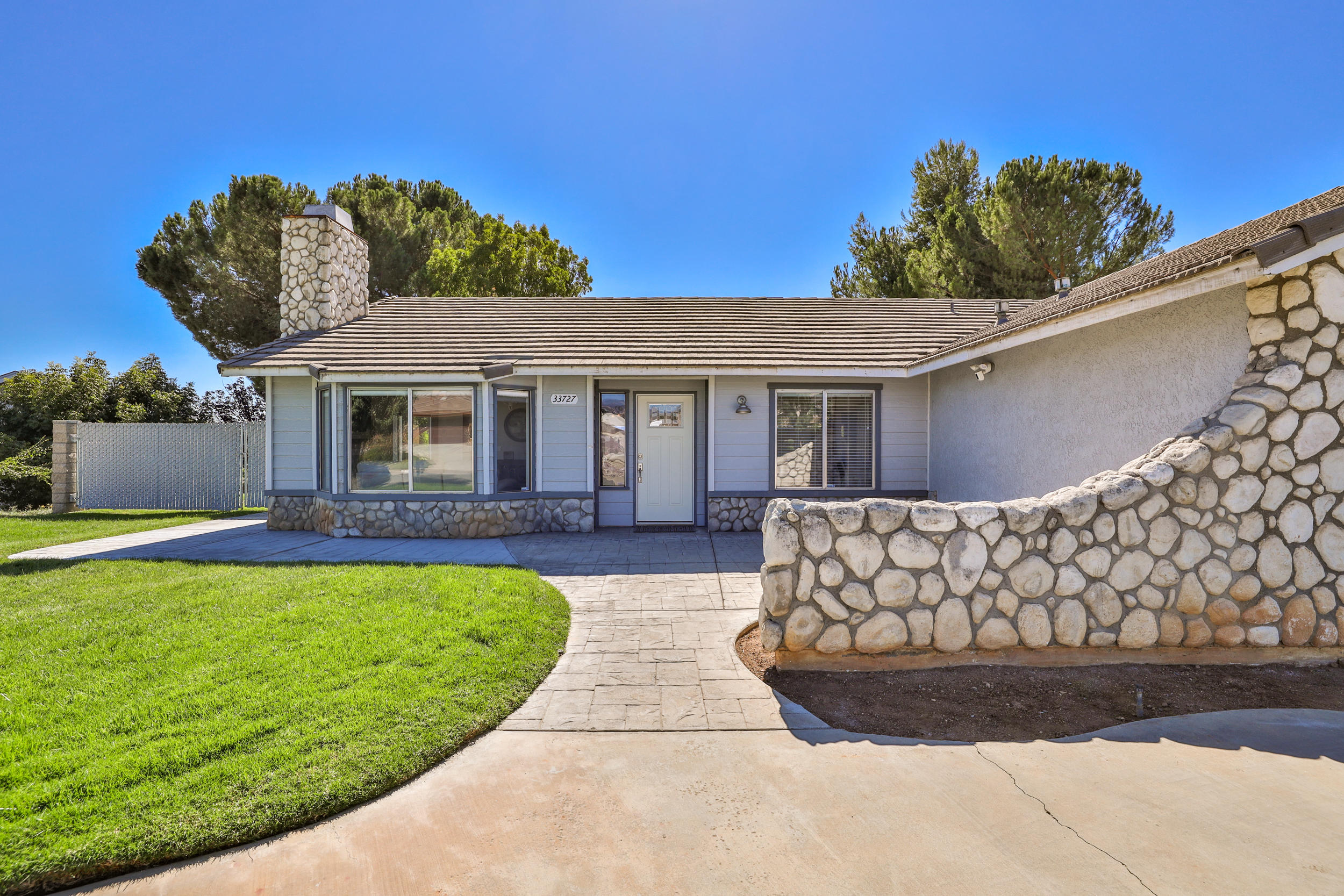 33727 Liberty Road Yucaipa, CA 92399 - Photo 31 of 39 a front view of a house with garden