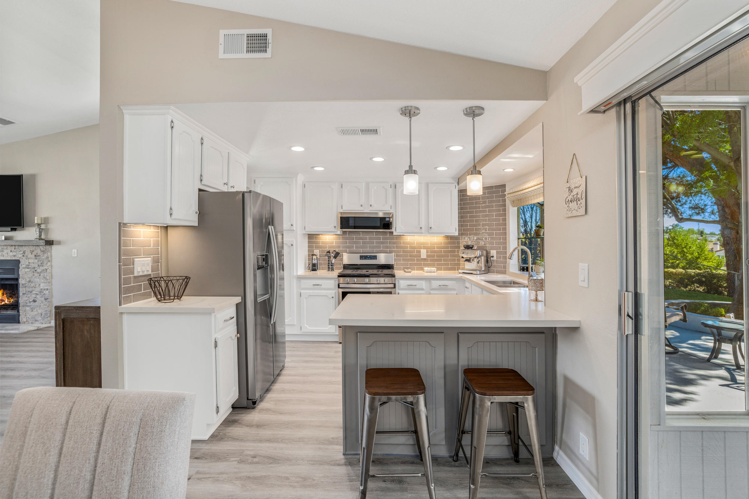 33727 Liberty Road Yucaipa, CA 92399 - Photo 8 of 39 a kitchen with stainless steel appliances kitchen island a table chairs sink and cabinets