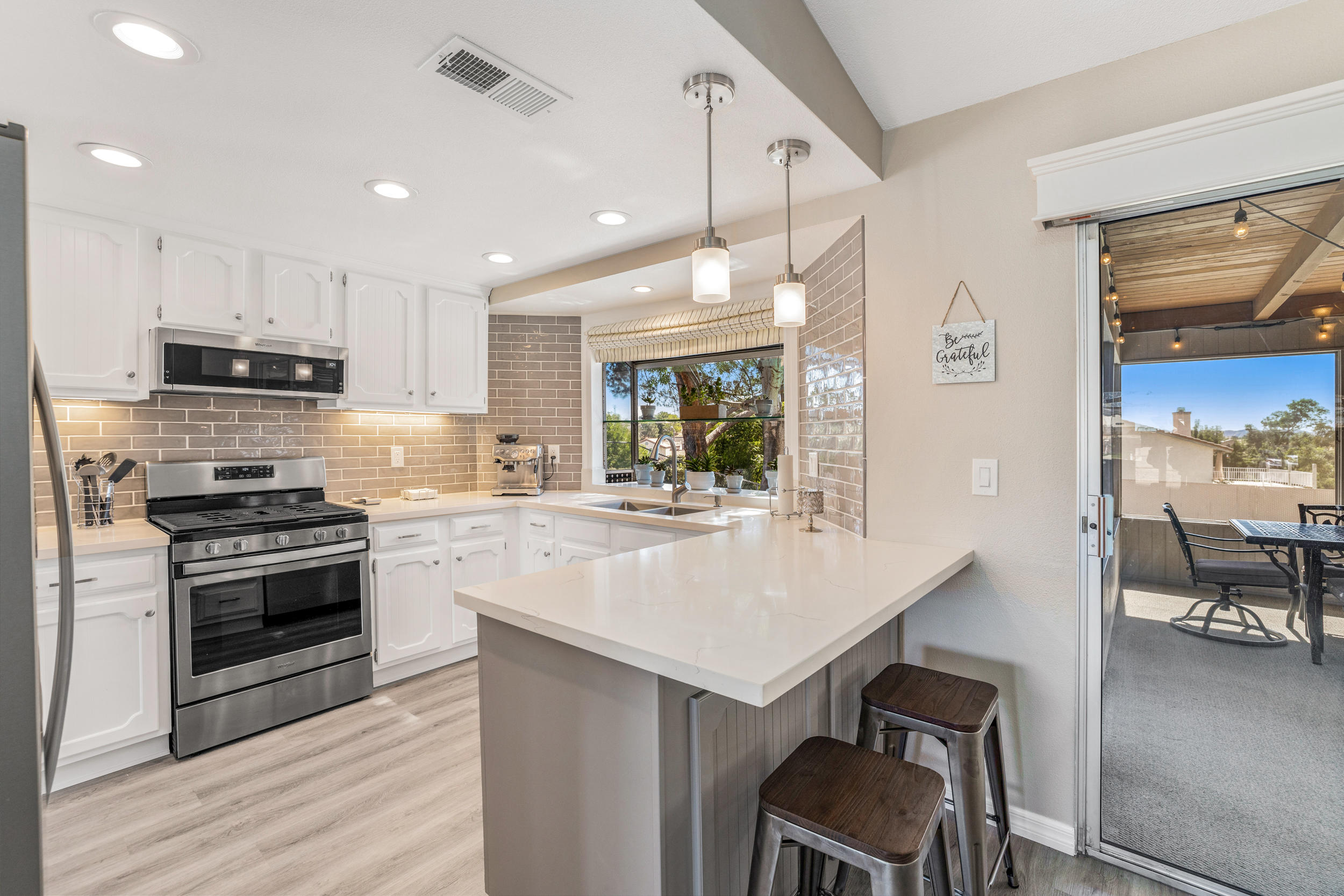 33727 Liberty Road Yucaipa, CA 92399 - Photo 9 of 39 a kitchen with kitchen island a stove and a wooden floors