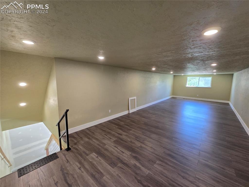33036 Meadow Ridge Lane Trinidad, CO 81082 - Photo 47 of 50 Loft/bonus room featuring a textured ceiling and dark hardwood / wood-style flooring
