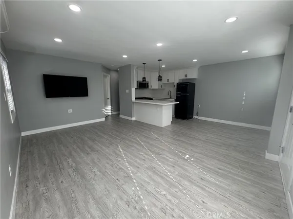 a view of a kitchen with kitchen island microwave and stove