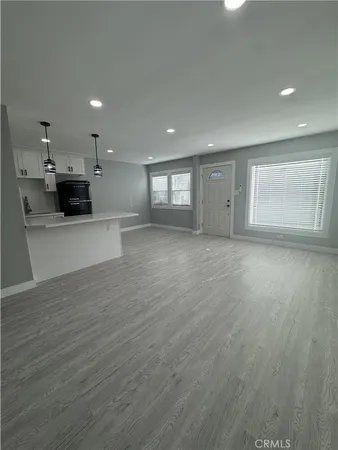 a view of a kitchen with a sink and a large window