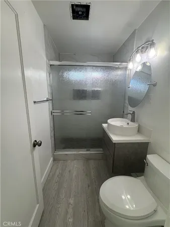 a white toilet sitting next to a bathroom sink
