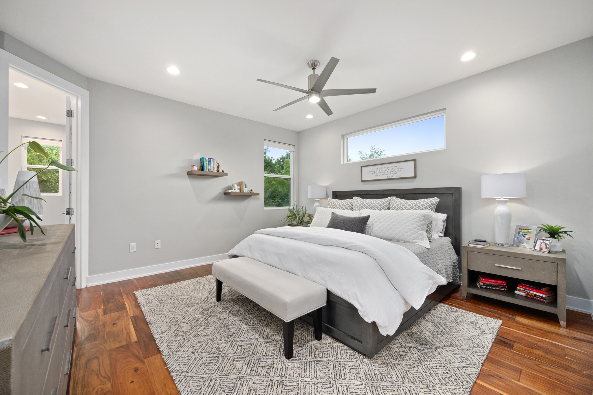 1103 Saucedo Street, Unit 1 Austin, TX 78721 - Photo 28 of 40 Hardwood floors and generous natural light create an inviting atmosphere in this primary bedroom.