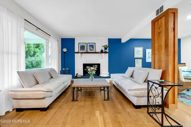 a kitchen with stainless steel appliances granite countertop white cabinets a stove top oven with wooden floor